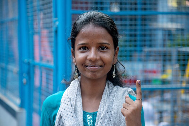 First-time voter Visaalini, 19, shows her ink-marked finger after voting in Chennai. EPA 