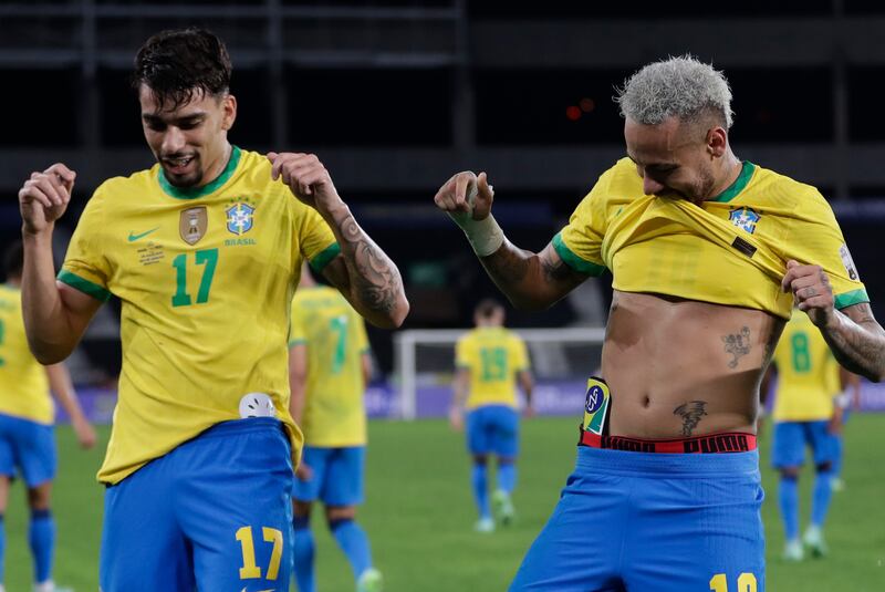 Brazil's Lucas Paqueta, left, celebrates with teammate Neymar after scoring his side's opening goal against Peru during the Copa America semi-final at Nilton Santos stadium in Rio de Janeiro.