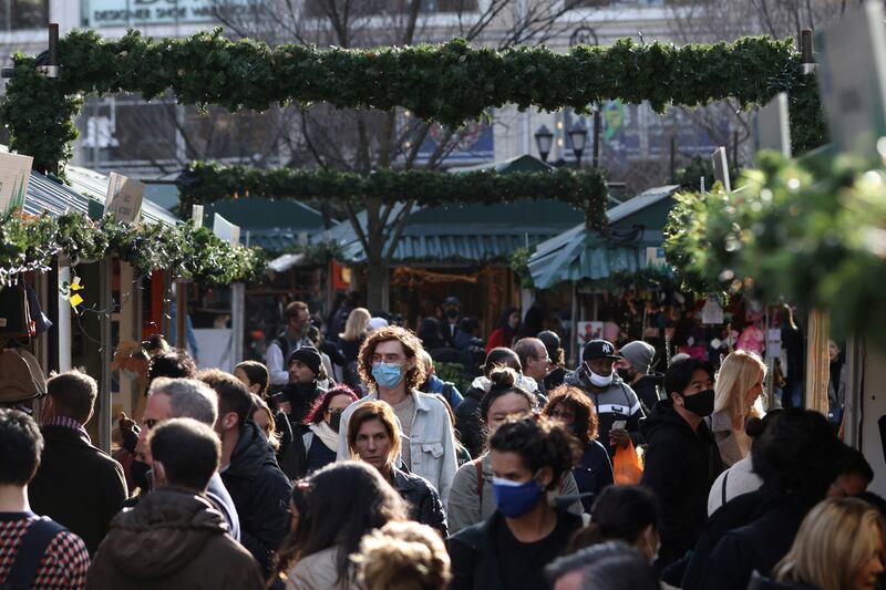 People walk through Union Square Holiday Market, in New York, as the Omicron coronavirus variant continues to spread. Reuters