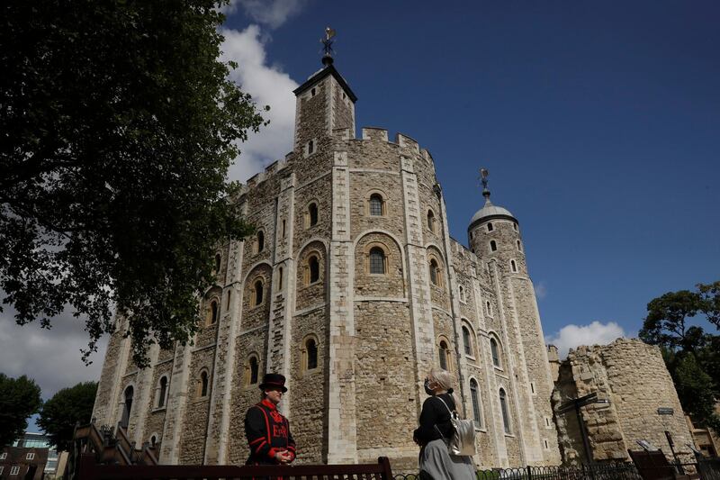 A Yeoman Warder speaks to a visitor as the Tower of London reopens. AP Photo