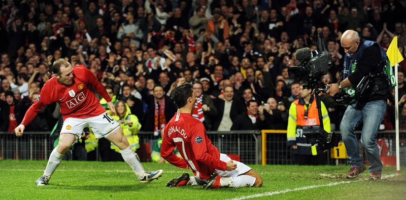 Cristiano Ronaldo celebrates with Wayne Rooney after scoring for Manchester United against Inter Milan during their Champions League match at Old Trafford on March 11, 2009. AFP
