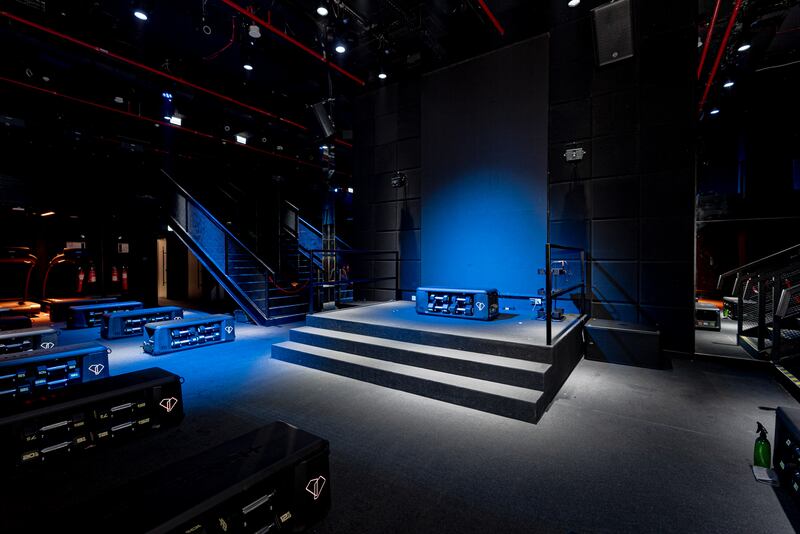 The HIIT studio has a stage, DJ booth, individual weights stations and treadmills, lining the two-storey room. 