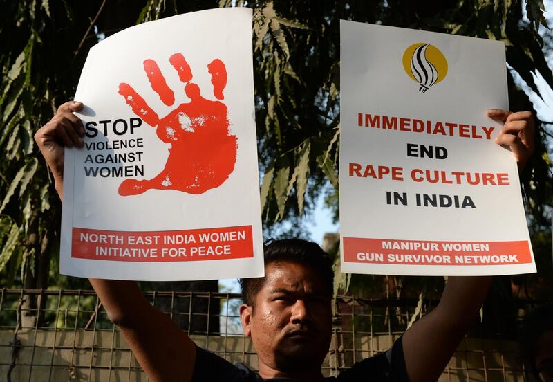 (FILES) This file photo taken on February 21, 2017 shows an Indian social activist holding placards during a protest against a rape at Hauz Khas village in New Delhi.
Amid growing pressure on Indian police over the handling of rape cases, dozens of new support centres for women victims of sexual violence are to be opened across the country under an scheme announced on January 23. / AFP PHOTO / SAJJAD HUSSAIN