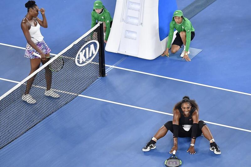 Serena Williams falls to the ground after winning the Australian Open final. Andy Brownbill / AP Photo