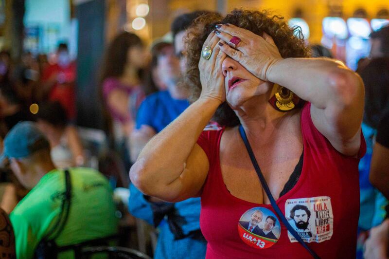 A supporter of Brazilian presidential candidate for the Workers' Party Fernando Haddad reacts during the general election vote count in Sao Salvador square, Rio de Janeiro. AFP