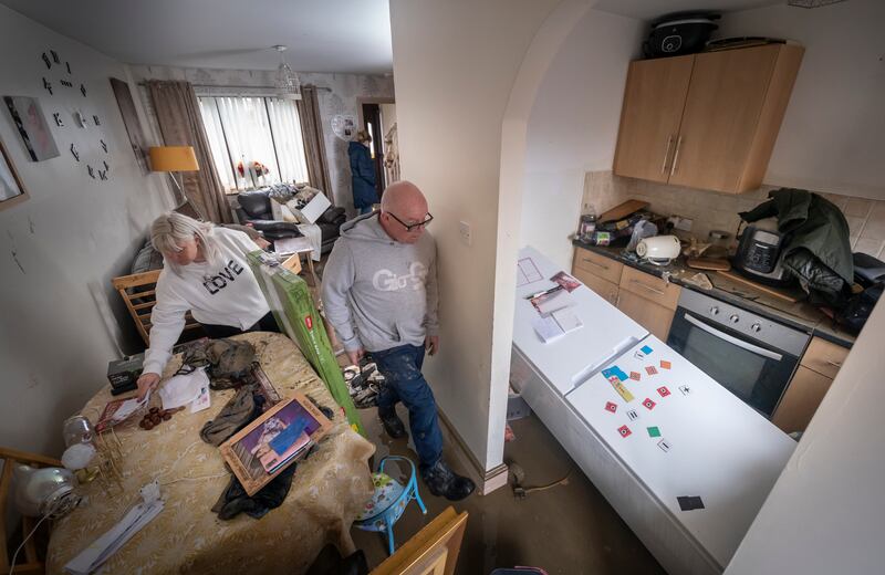 Lynsey France and David Pickering inspect flood damage in their home in Catcliffe near Rotherham, South Yorkshire, northern England. PA