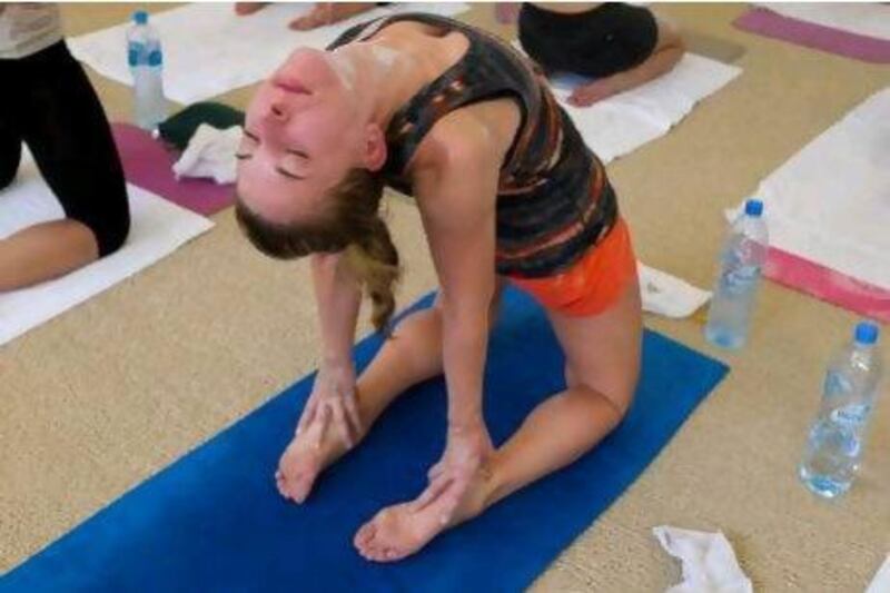 The National's Melanie Swan performs camel pose at a Bikram Yoga class at Club Stretch in Dubai Marina. Razan Alzayani / The National