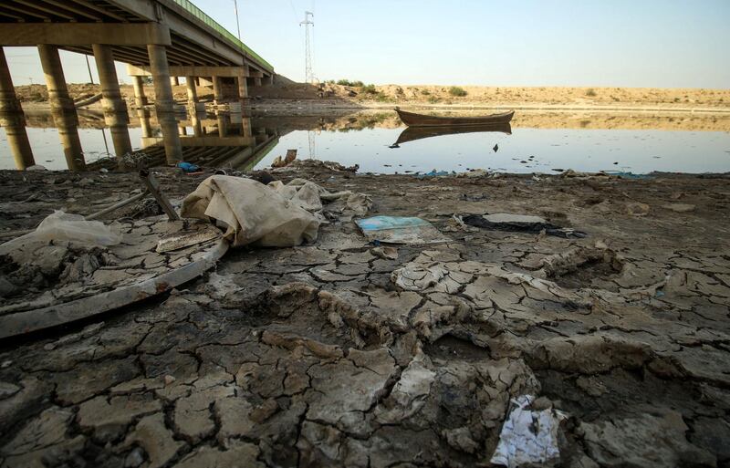 A picture taken on March 20, 2018 shows a view of the dried-up shore of an irrigation canal near the village of Sayyed Dakhil, to the east of Nasariyah city some 300 kilometres (180 miles) south of Baghdad. - Farmers in Sayyed Dakhil have traditionally lived off their land where there used to be no need for wells, but a creeping drought is now threatening agriculture and livelihoods in the area.
Weather patterns are largely to blame for the crisis, but while rain accounts for 30 percent of Iraq's water resources, the remaining 70 percent is drawn from rivers and marshes shared with Iran, Turkey and Syria, which has played a part in Iraq's drought. (Photo by HAIDAR MOHAMMED ALI / AFP)