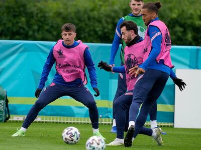 England's Mason Mount, left, and England's Ben Chilwell, second left, during a team training session at Tottenham Hotspur training ground in London, Monday, June 21, 2021 one day ahead of the Euro 2020 soccer championship group D match against Czech Republic. After a positive test for Scotland midfielder Billy Gilmour, Mason Mount and Ben Chilwell have been told to self isolate following "interaction" with Gilmour during England's 0-0 draw with Scotland at Wembley Stadium on Friday. (AP Photo/Frank Augstein)
