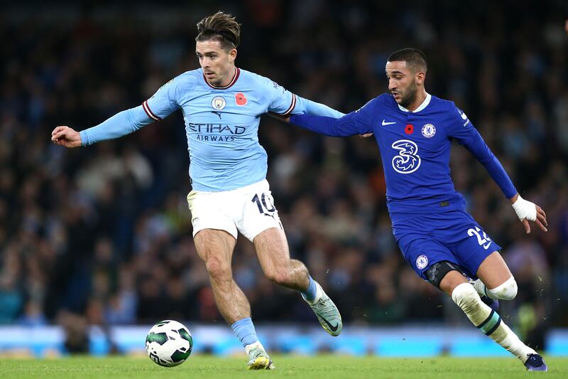 MANCHESTER, ENGLAND - NOVEMBER 09: Jack Grealish of Manchester City is challenged by Hakim Ziyech of Chelsea during the Carabao Cup Third Round match between Manchester City and Chelsea at Etihad Stadium on November 09, 2022 in Manchester, England. (Photo by Jan Kruger / Getty Images)