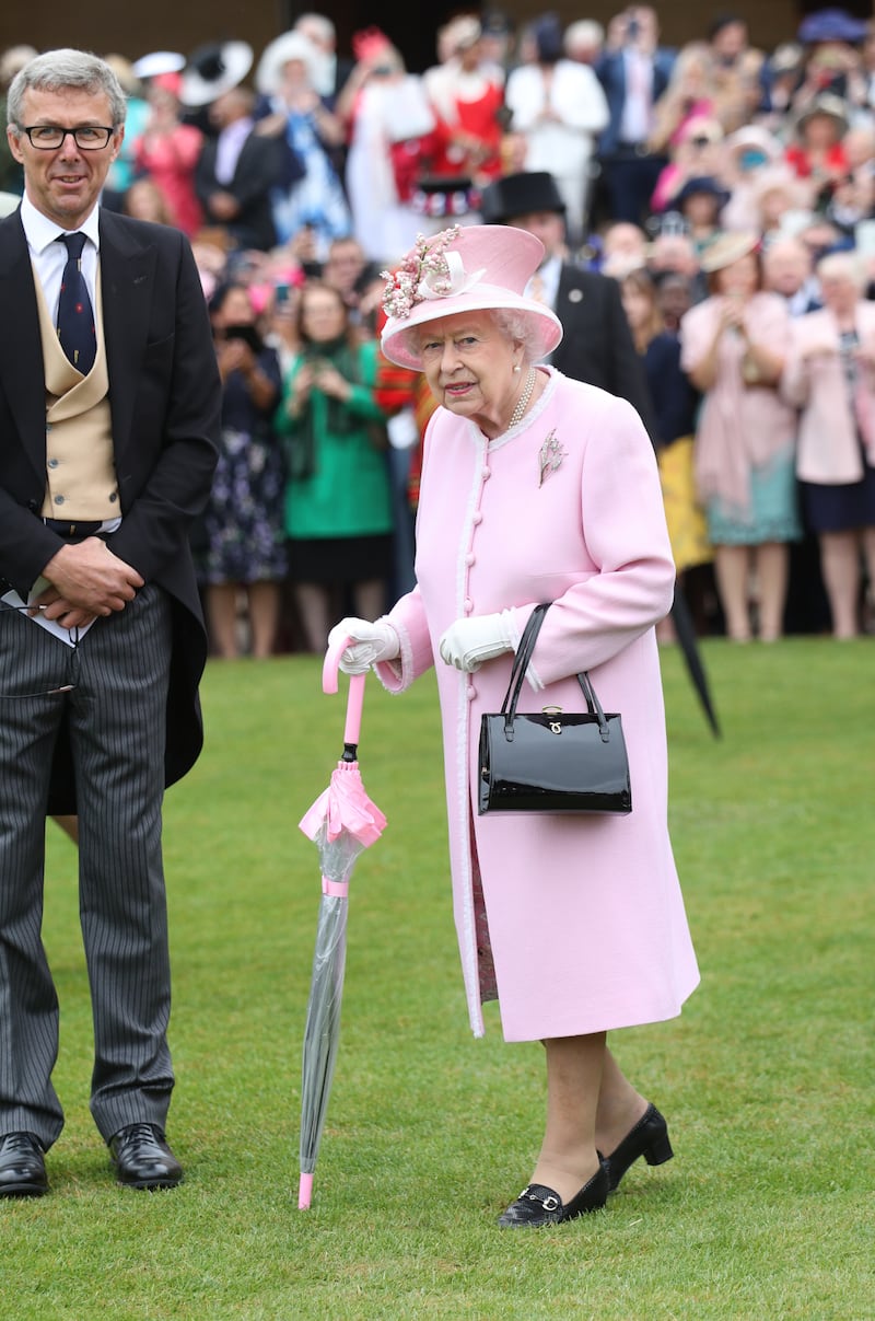 Queen Elizabeth II, wearing light pink, attends the Royal Garden Party at Buckingham Palace on May 29, 2019 in London, England. Getty Images