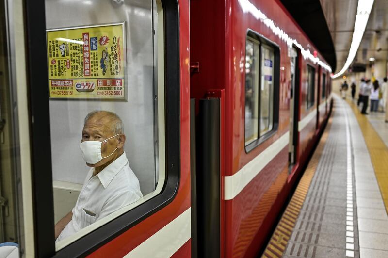 An elderly man sits on a train in Tokyo, Japan. AFP