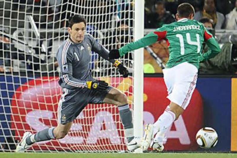 Mexico's Javier Hernandez, right, dribbles past Hugo Lloris, the France goalkeeper, to score his team's first goal.