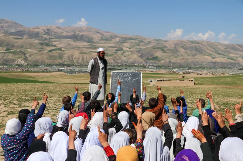 Afghan children attend class at an open-air school in Fayzabad district, Badakhshan province. AFP