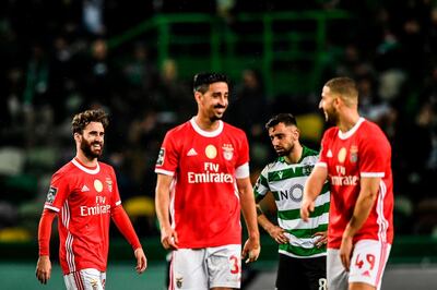 Benfica's forward Rafa da Silva (L) celebrates his goal during the Portuguese league football match between Sporting CP and SL Benfica at the Jose Alvalade stadium in Lisbon on January 17, 2020. / AFP / PATRICIA DE MELO MOREIRA
