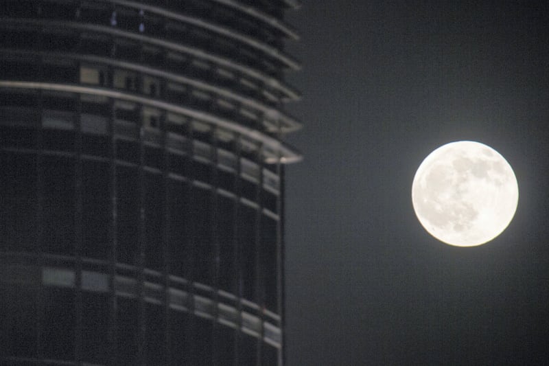 Dubai, United Arab Emirates, August 7, 2017:    A full moon rises above the Burj Khalifa in the Emaar Square area of Dubai on August 7, 2017. Christopher Pike / The National

Reporter:  N/A
Section: News