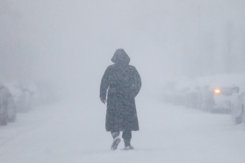 A woman walks down the street  in Long Beach, New York. Shannon Stapleton / Reuters