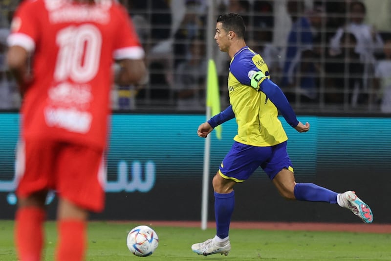 Al Nassr forward Cristiano Ronaldo runs with the ball. AFP