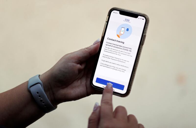 FILE PHOTO: The coronavirus disease (COVID-19) contact tracing smartphone app of Britain's National Health Service (NHS) is displayed on an iPhone in this illustration photograph taken in Keele, Britain, September 24, 2020. REUTERS/Carl Recine/File Photo