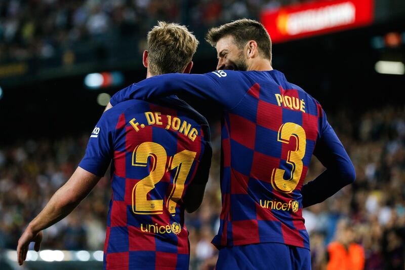 Barcelona's Spanish defender Gerard Pique  is congratulated by teammate Frenkie De Jong after scoring. AFP