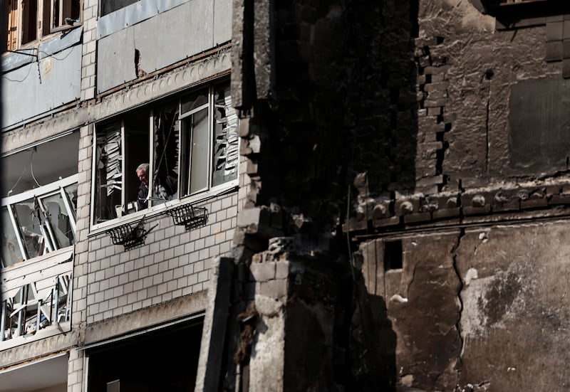 A man looks out of his window, amid Russia's invasion of Ukraine, in Borodianka. Reuters