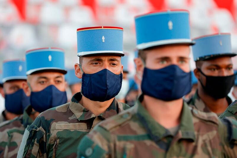 French soldiers of 2nd Regiment de Dragons, who worked during the coronavirus pandemic, practice their marching formation before the July 14 Bastille Day Parade at the Place de la Concorde in Paris. This year's event is being held as a tribute to health workers fighting the pandemic.  AFP