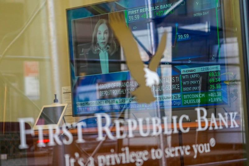 A television screen displays the stock price of First Republic Bank inside one of its branches in New York's Financial District. AP