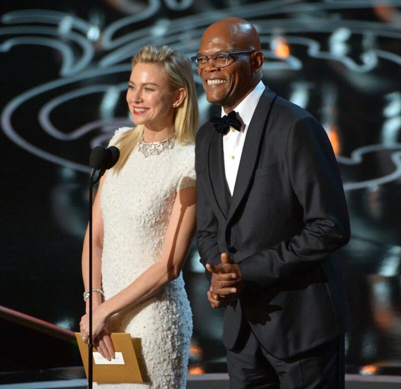 Naomi Watts, left, and Samuel L Jackson speak during the Oscars. John Shearer / Invision / AP