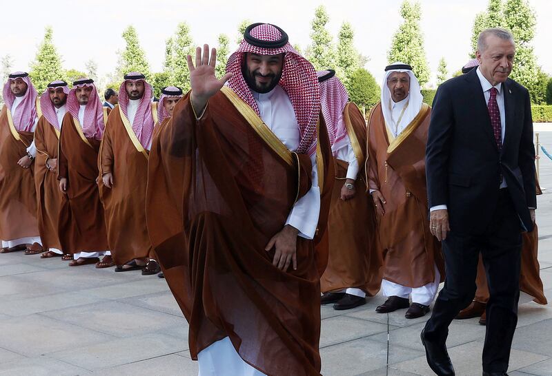 Crown Prince of Saudi Arabia Mohammed bin Salman waves as he is welcomed by Turkey's President Recep Tayyip Erdogan (R) during an official ceremony at the Presidential Complex in Ankara. AFP