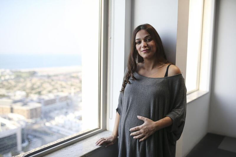 Laudy Charabaty, expecting her second child, is pleased with the longer maternity leave her company offers, saying returning to work six weeks after the birth of her first was too soon. Sarah Dea / The National