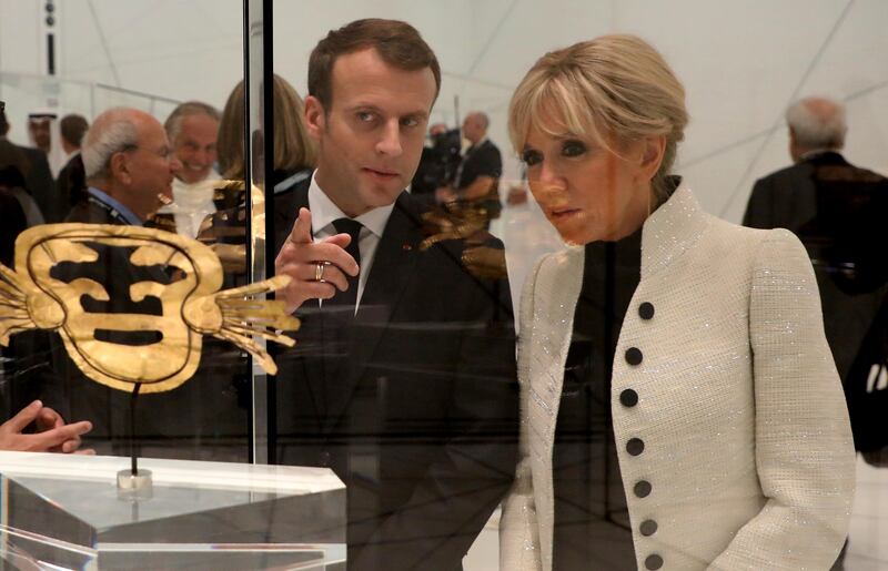 French President Emmanuel Macron and his wife Brigitte Macron visit the Louvre Abu Dhabi Museum during its inauguration in Abu Dhabi, United Arab Emirates, Wednesday, Nov. 8, 2017. (Ludovic Marin/Pool photo via AP)