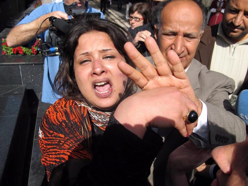 Iman Obeidi, who claims to have spent two days in detention after being arrested at a checkpoint in Tripoli, and later sexually assaulted while in custody, attempts to explain her story to journalists in Tripoli, in 2011. Mohamed Messara / EPA