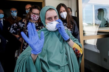 Silvia Romano, an Italian aid worker who was kidnapped by gunmen in Kenya 18 months ago, arrives at Ciampino military airport in Rome. Italian Ministry of Foreign Affairs/Handout 