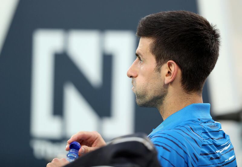 Abu Dhabi, United Arab Emirates - Reporter: Jon Turner: Novak Djokovic drinks some water during the third place play-off between Novak Djokovic v Karen Khachanov at the Mubadala World Tennis Championship. Saturday, December 21st, 2019. Zayed Sports City, Abu Dhabi. Chris Whiteoak / The National