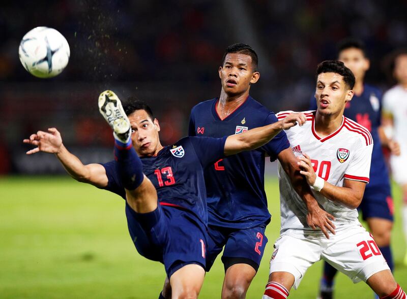 Thailand's Nitipong Selanon clears the ball. EPA