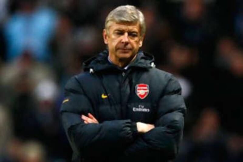 A glum Arsenal manager Arsene Wenger watches his side crash to a 3-0 defeat against Manchester City.