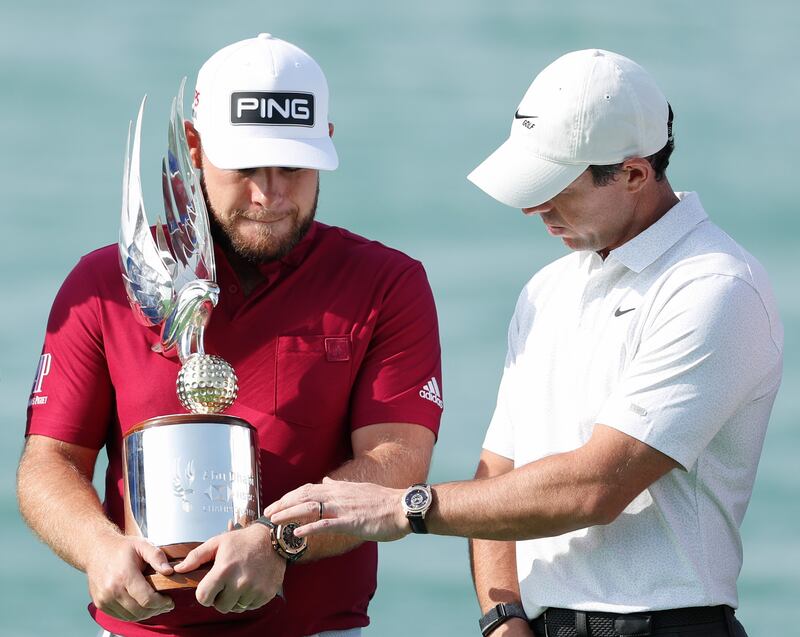 Rory McIlroy inspects the Abu Dhabi HSBC Championship trophy, held by last year's winner Tyrrell Hatton. Getty Images
