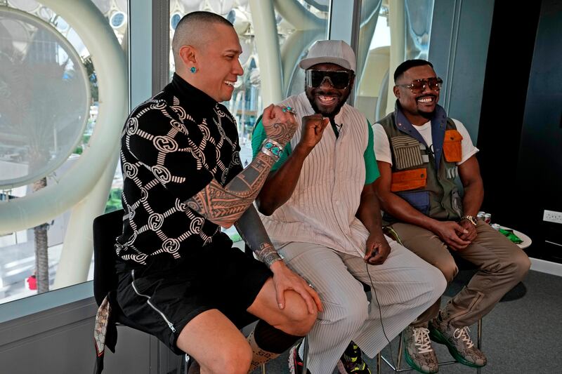 Taboo, left, fist-bumps will.i.am as the band meet the press at the Expo site. AP