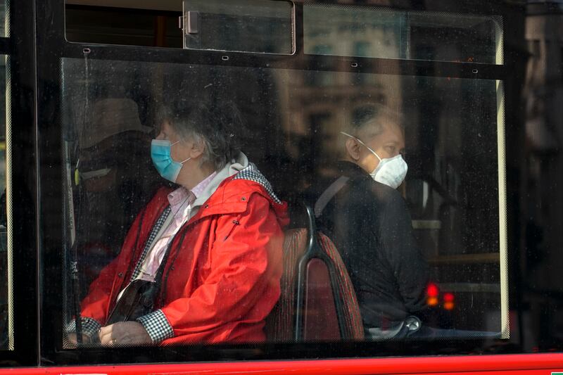 Bus passengers in London. Masks are not mandatory in indoor settings such as shops, restaurants and bars in England. AP Photo