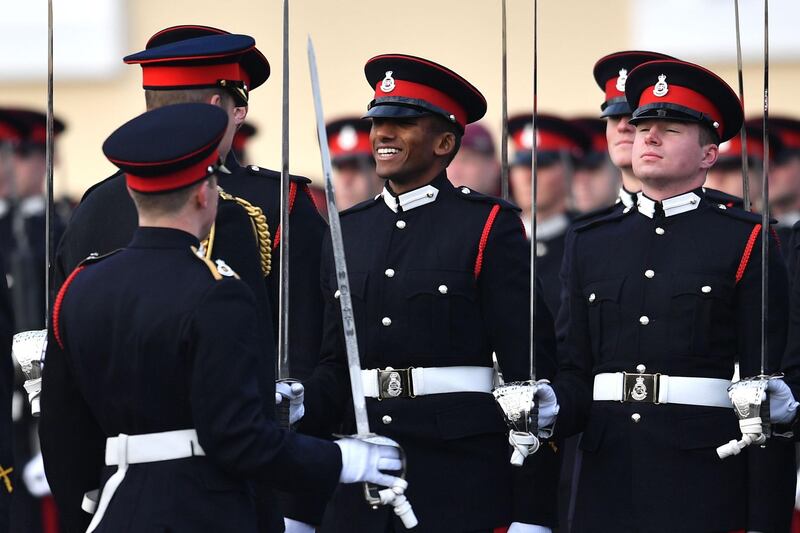 Britain's Prince William inspects the graduating officer cadets.  AFP