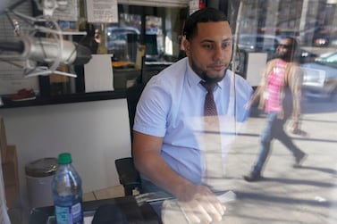Aderlin Abreu, a dispatcher at Super Class Radio Dispatch, takes calls in the Bronx borough of New York. More than 100 private hire cab firms have closed their doors since 2015 as ride hailing apps have grown in popularity. AP 