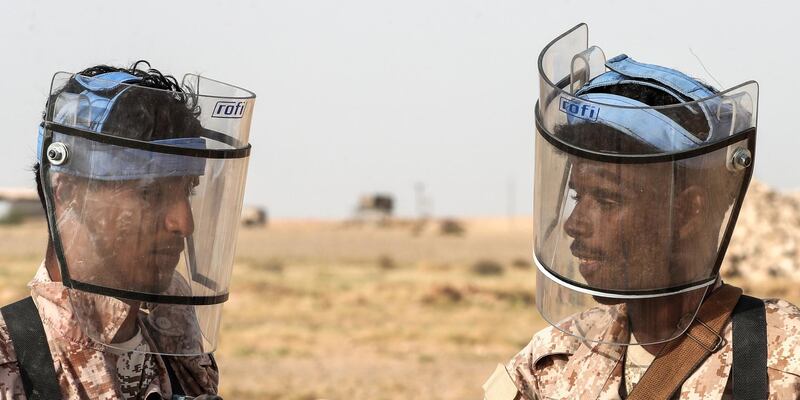 Yemeni soldiers discuss their minesweeping training exercise. AFP