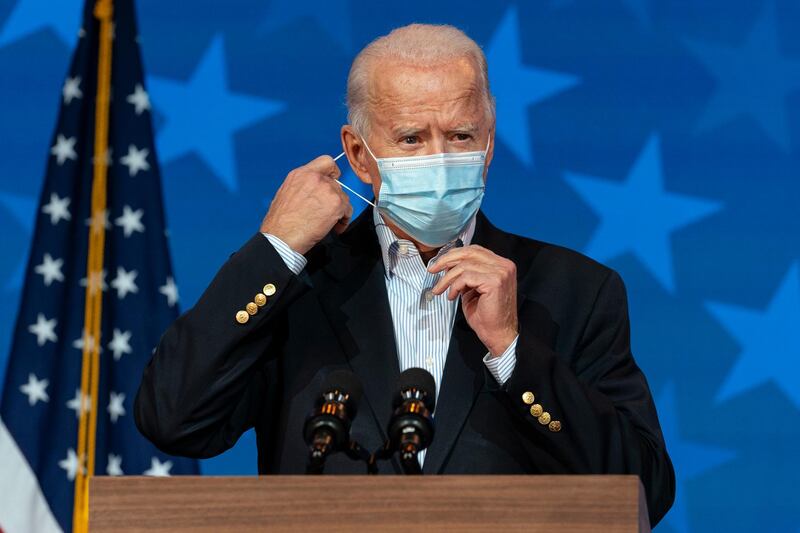 Democratic presidential candidate former Vice President Joe Biden removes his face mask to speak at The Queen theater in Wilmington, Delaware. AP Photo