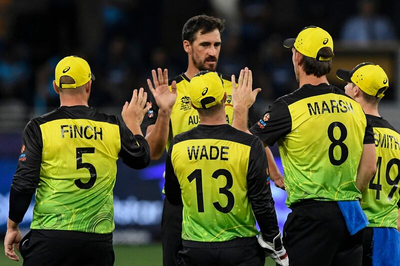 Australia's Mitchell Starc, centre, celebrates with his teammates after taking the wicket of Sri Lanka's Wanindu Hasaranga. AFP