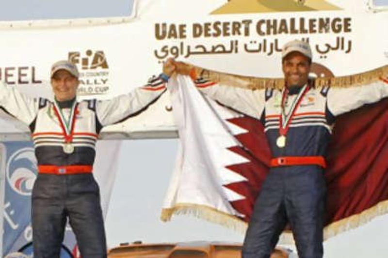 Qatar's Nasser al Attiyah, right, is the first Arab driver to win the UAE Desert Challenge in 15 years.  The UAE's Yahya Alhelei, left,  took second.