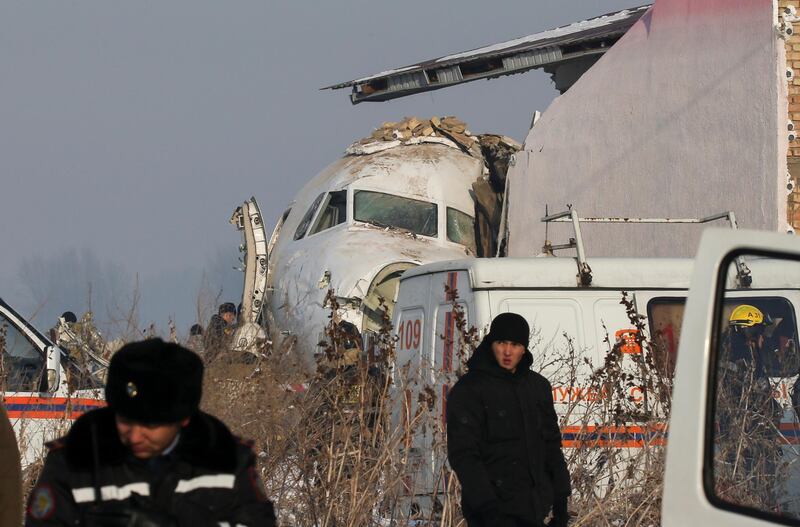 Emergency and security personnel are seen at the site of the plane crash near Almaty. Reuters