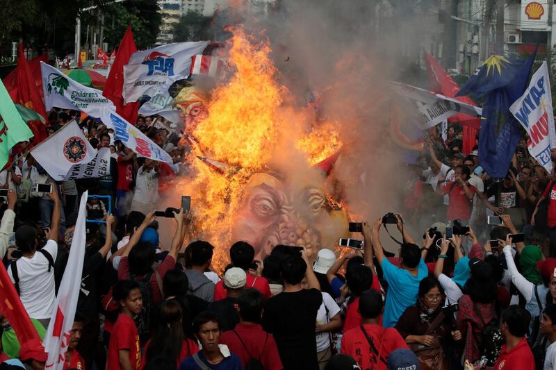 Protesters burn effigies of Philippine President Rodrigo Duterte, US President DOnald Trump and Chinese president Xi Jinping during a demonstration in Manila, Philippines. EPA