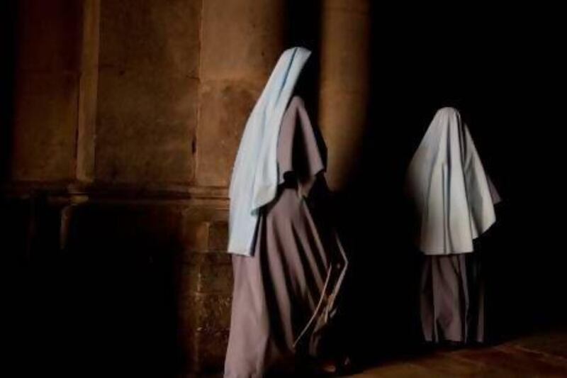 Nuns walk during the Sunday Easter mass at the Church of the Holy Sepulchre, traditionally believed to be the site of the crucifixion of Christ, in Jerusalem's Old City.