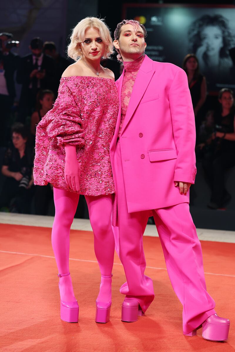 In matching fuchsia pink Valentino, Veronica Lucchesi and Dario Mangiaracina arrive for the 'Dead For A Dollar' premiere. Getty