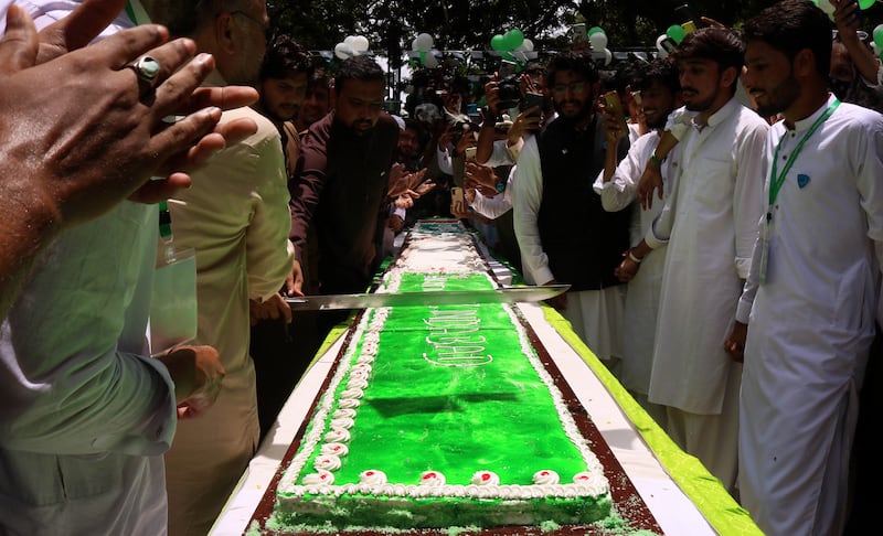The cutting of a cake to mark the anniversary. EPA